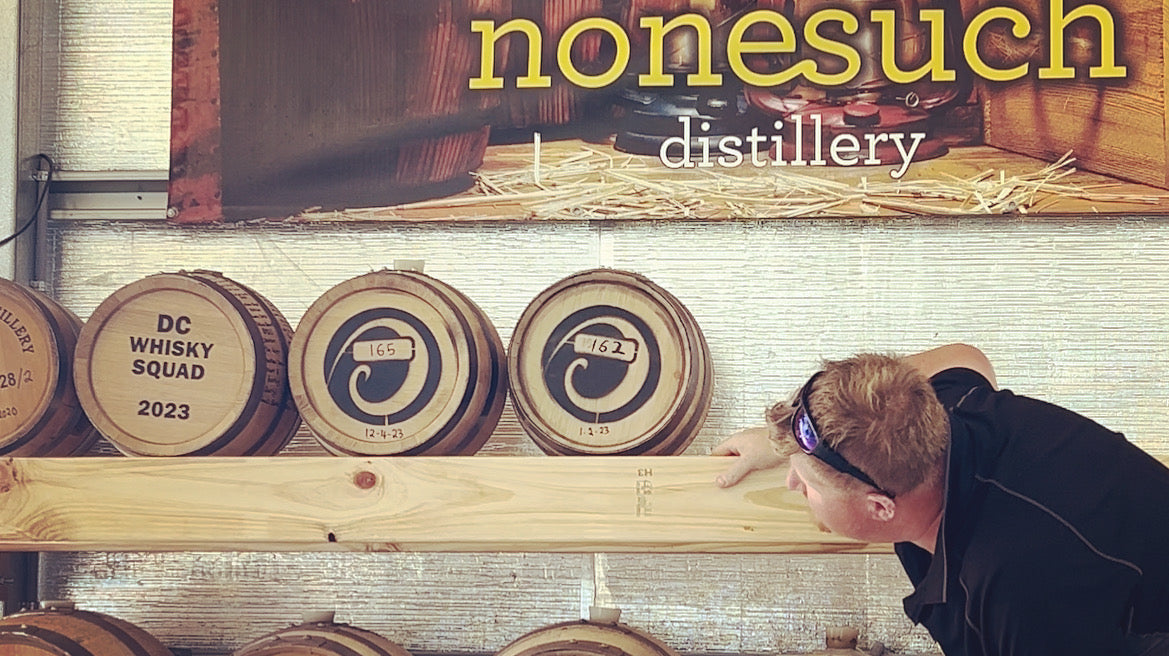 Distiller inspects maturing barrels of whisky at Nonesuch in Tasmania