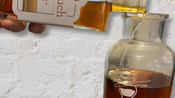 Nonesuch paradigm Tasmanian whisky being poured into a whiskey infinity bottle