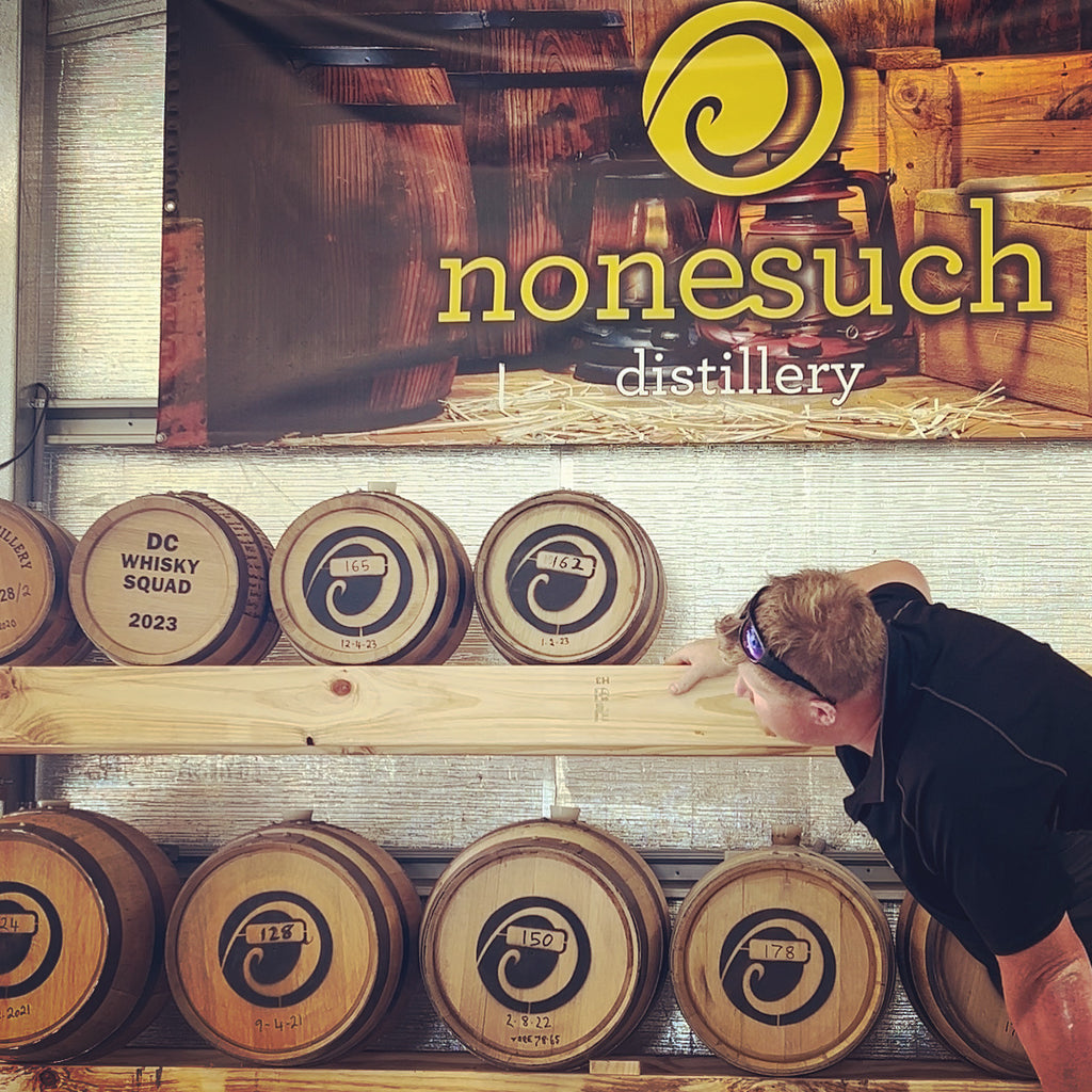 Distiller inspects maturing barrels of whisky at Nonesuch in Tasmania