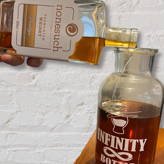 Nonesuch paradigm Tasmanian whisky being poured into a whiskey infinity bottle